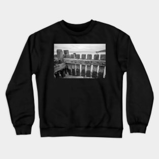 Close up of wooden sea defences protecting against coastal erosion Crewneck Sweatshirt